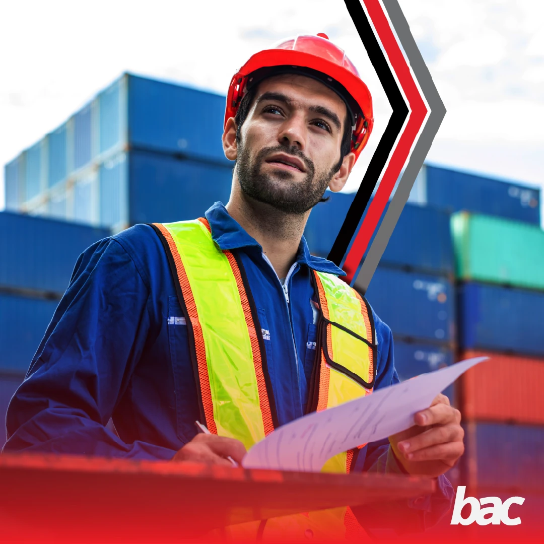 Logistics worker reviewing shipping documents at a container yard