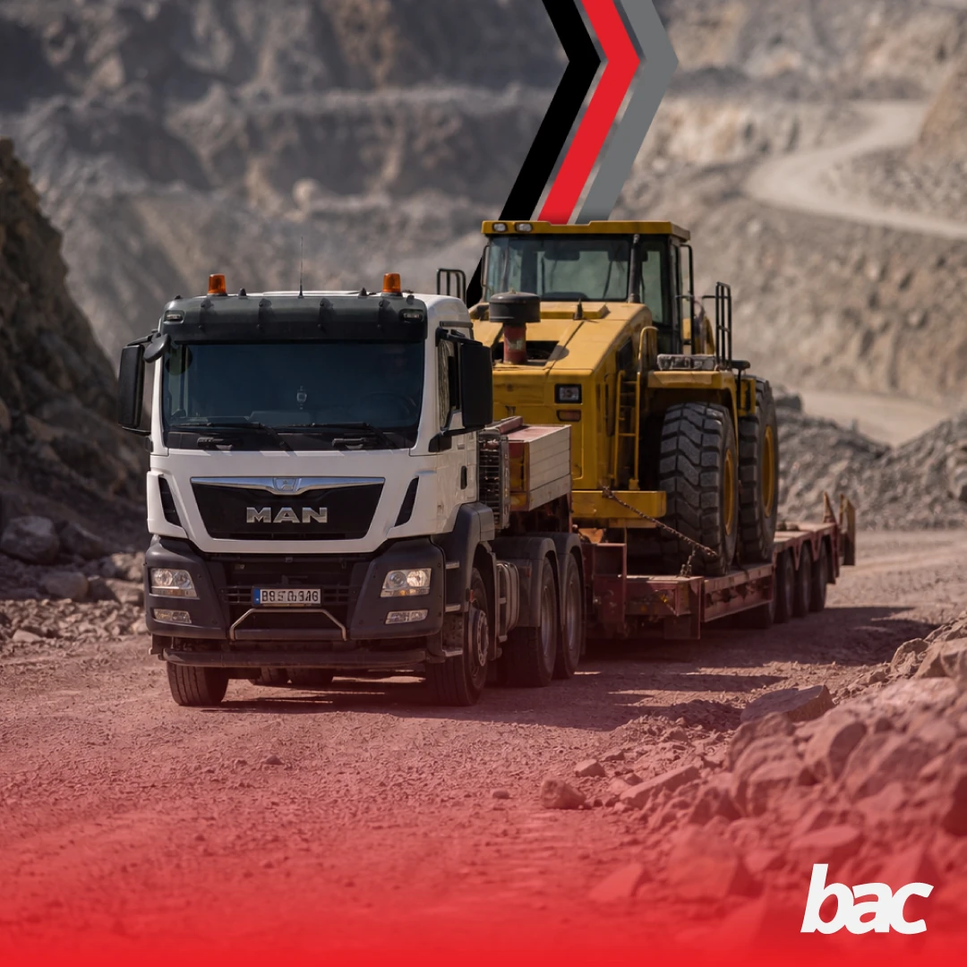 Mining truck transporting heavy equipment through a remote mine site